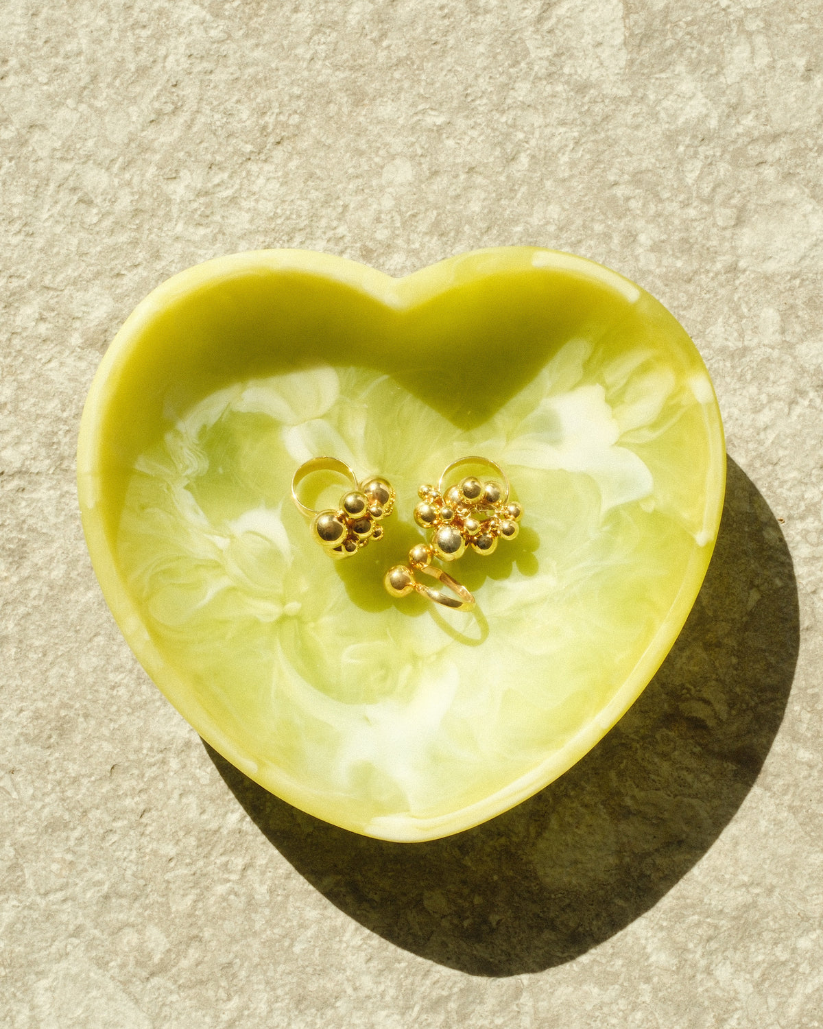 green heart bowl with gold cluster rings