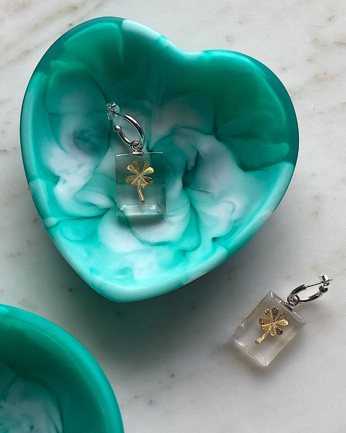 green heart trinket bowl with four leaf clover earrings