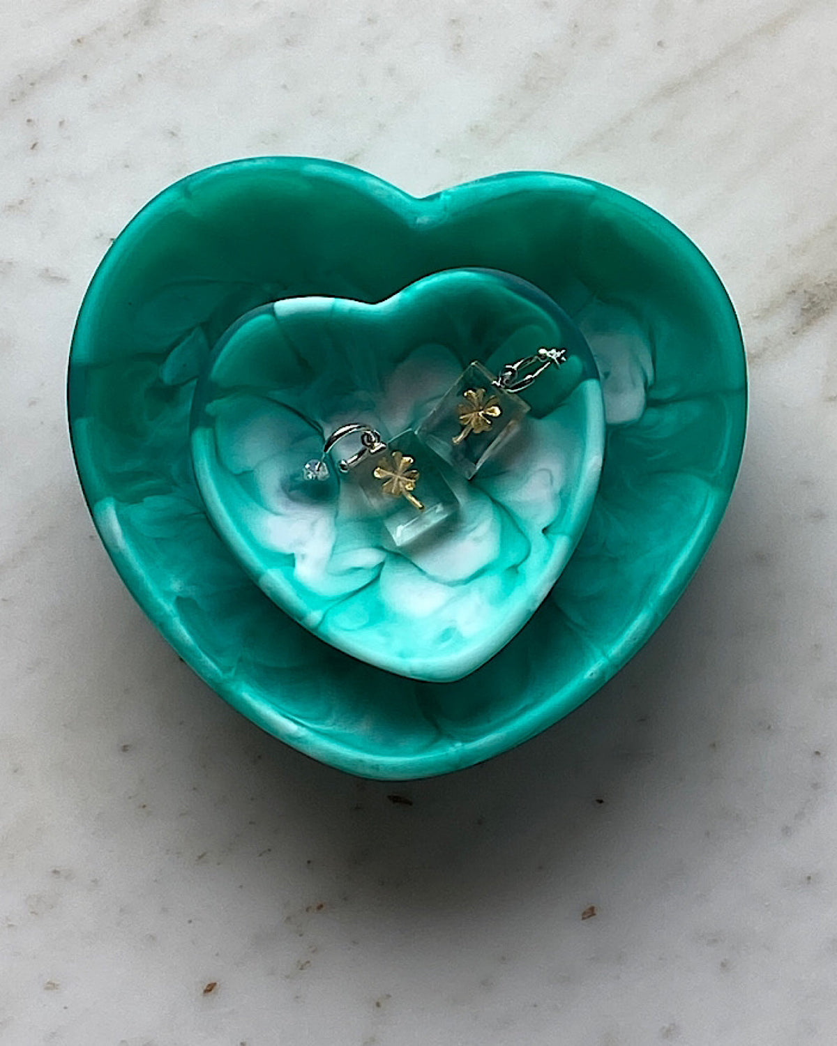 green heart trinket bowl with four leaf clover earrings