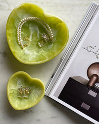 lime coloured heart dishes with jewellery inside them