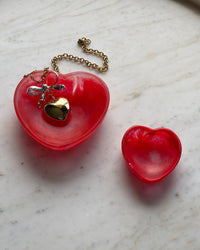 two red heart bowls with a heart pendant