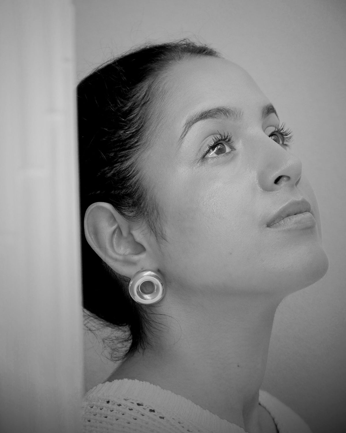 model wears a round hug indiana earrings pared store