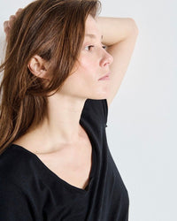 Woman wearing a black top against a white background