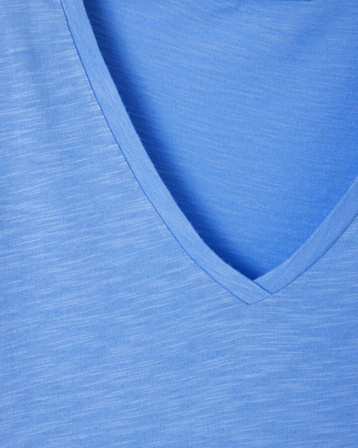 Close-up of a blue fabric with a V-neck design