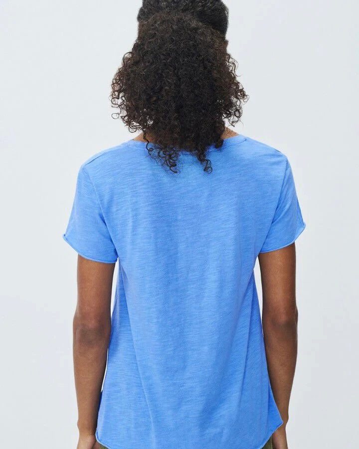 Person wearing a blue t-shirt against a plain background