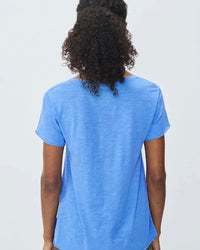 Person wearing a blue t-shirt against a plain background