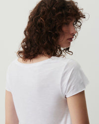 a model wears a white v short sleeve tshirt