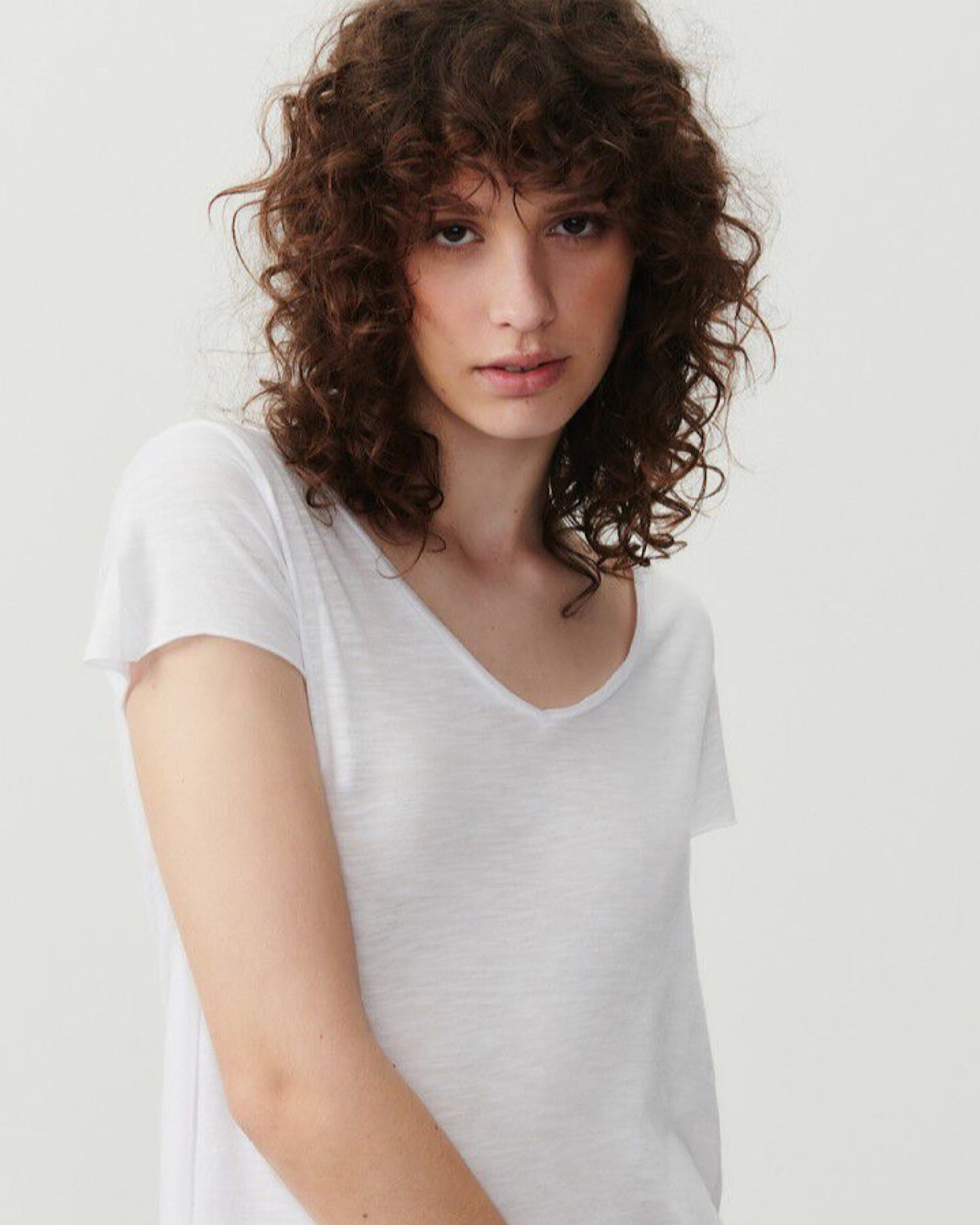 a model wears a white v short sleeve tshirt