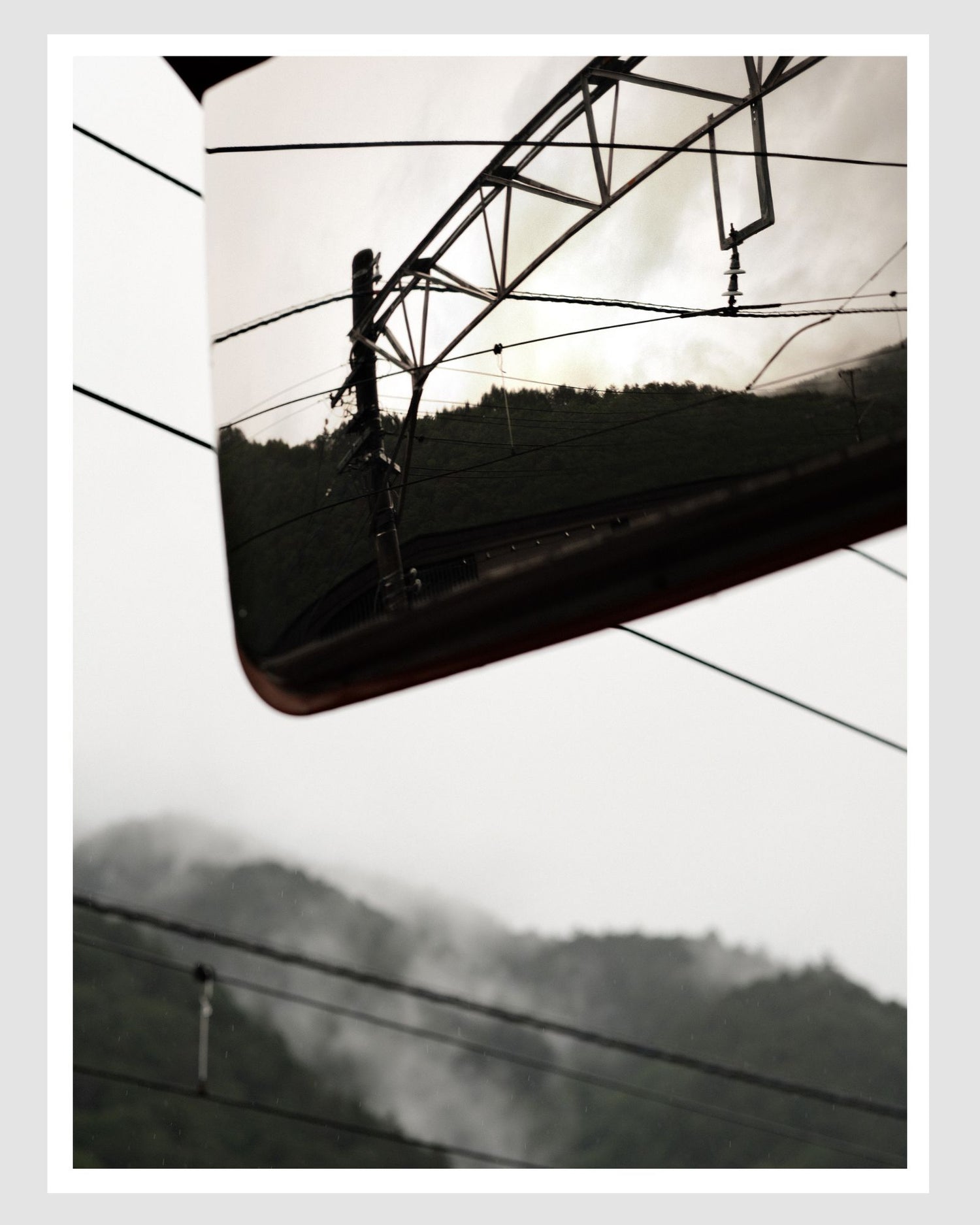 Electrical wires and poles against a cloudy sky in Japan