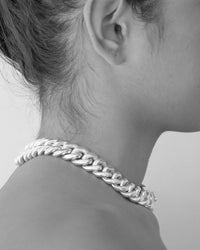 model wears a thick cuban link necklace