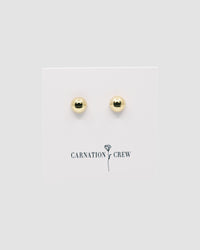 gold dome earrings on a carnation crew card