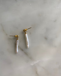 small long skinny tooth pearls on a gold stud