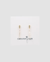 long skinny pearls with a gold stud on a carnation crew card