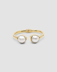 a gold cuff with baroque pearl ends