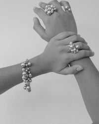 ball bracelet and rings on models hands