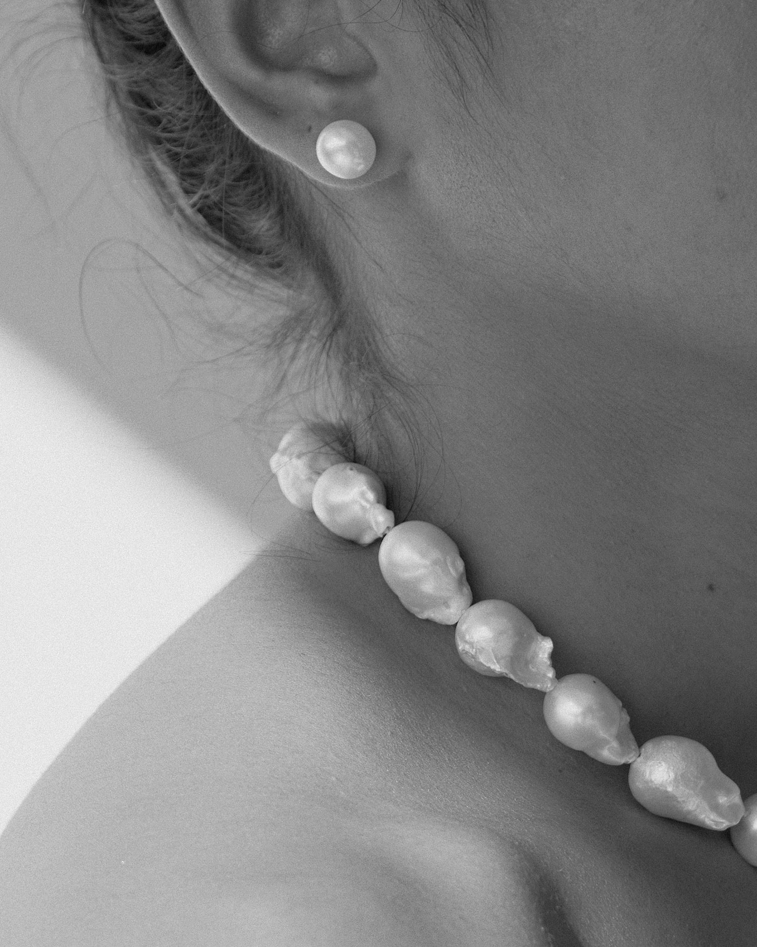 model wears baroque pearl necklace and pearl earrings