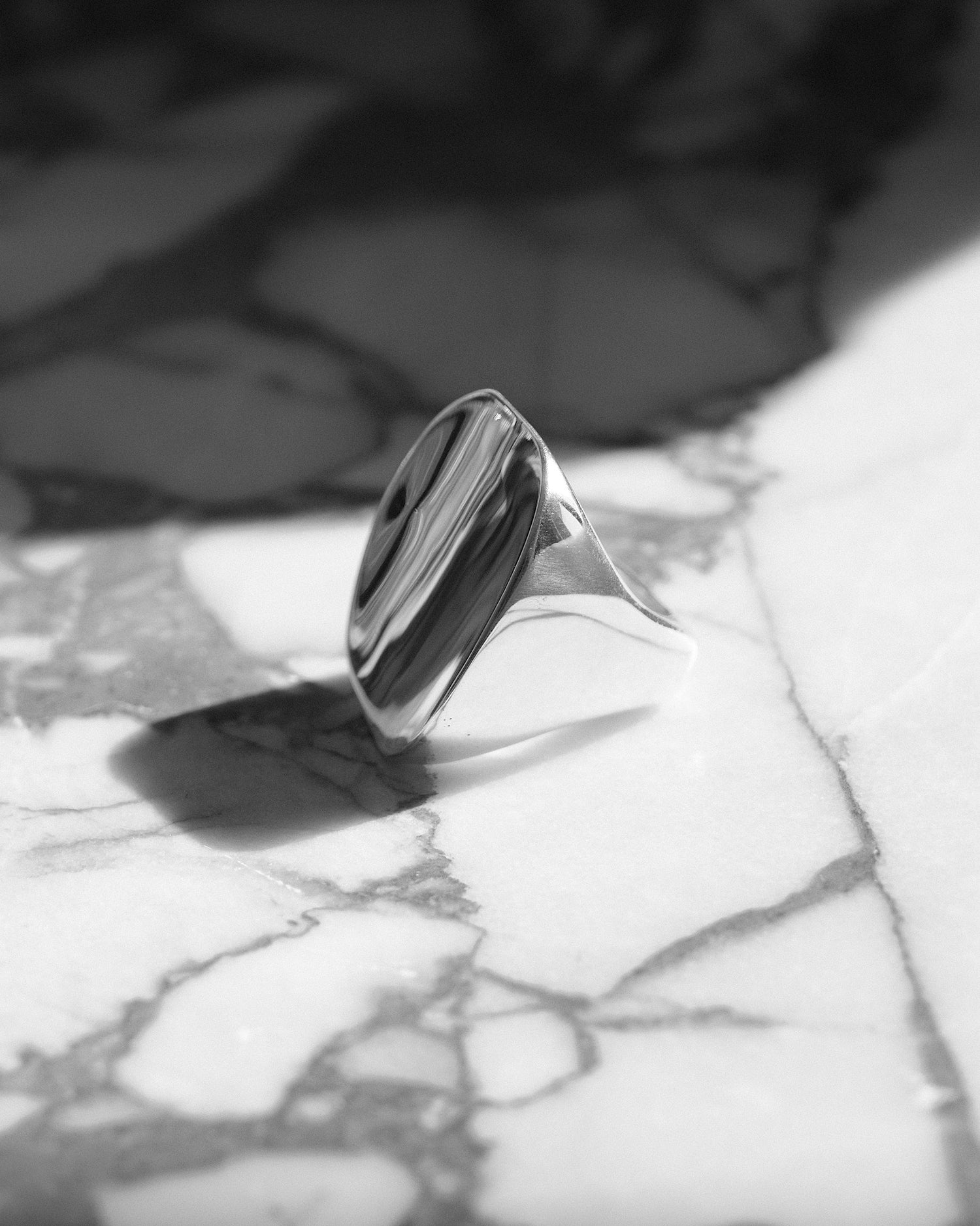 modern rectangle front silver ring on marble