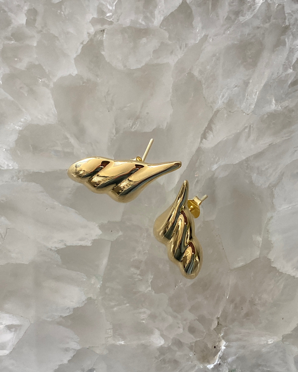 Sculptural gold pointed  earrings on crystal