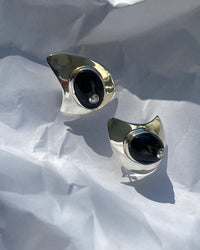 organic shaped silver earrings with a large onyx stone with a pearl centre