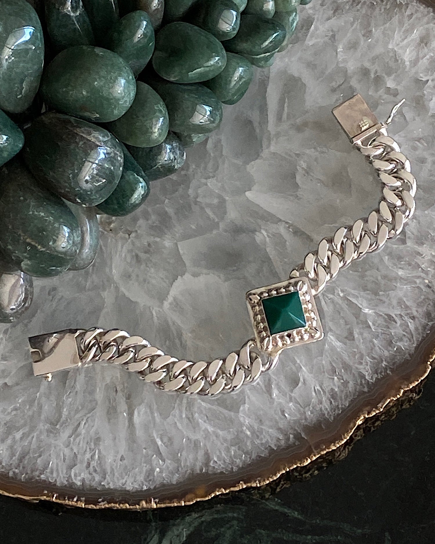 silver cuban chain bracelet set with a square pendant set with a green pyramid shaped stone