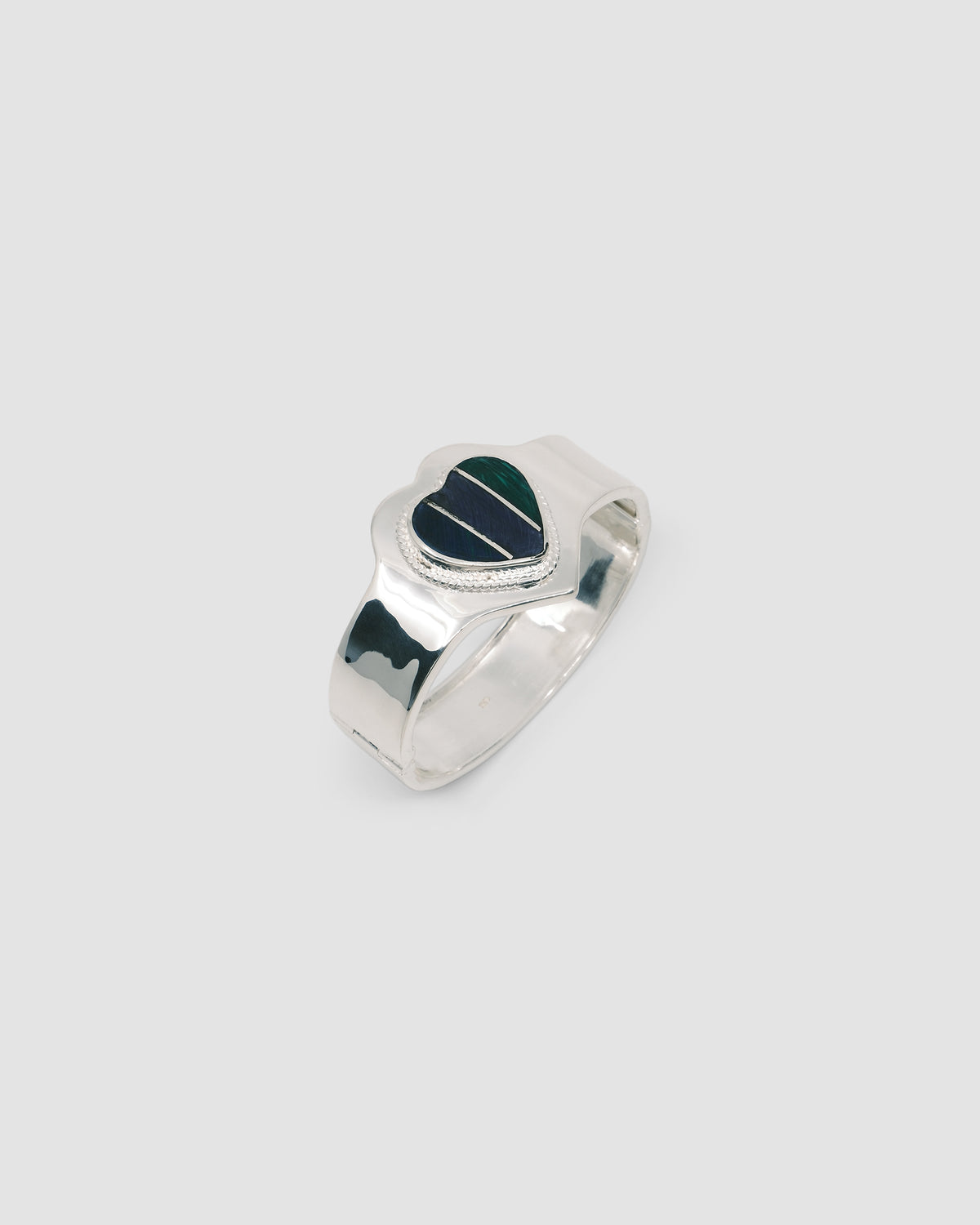 silver cuff bracelet with an inlaid heart striped blue, purple and green stone