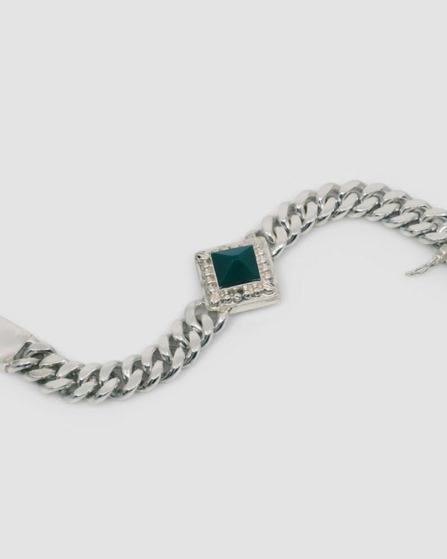 silver cuban chain link necklace with a square pendant set with a green pyramid stone