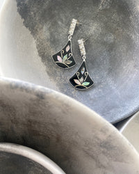 3 Pearl beads and a hanging black abalone fan shaped pendant  in a bowl