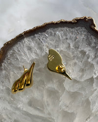 Sculptural gold pointed  earrings on crystal