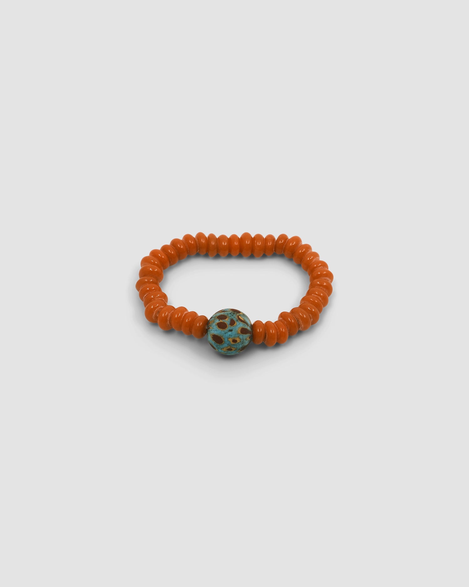 orange beaded bracelet with a central light blue mottled feature bead