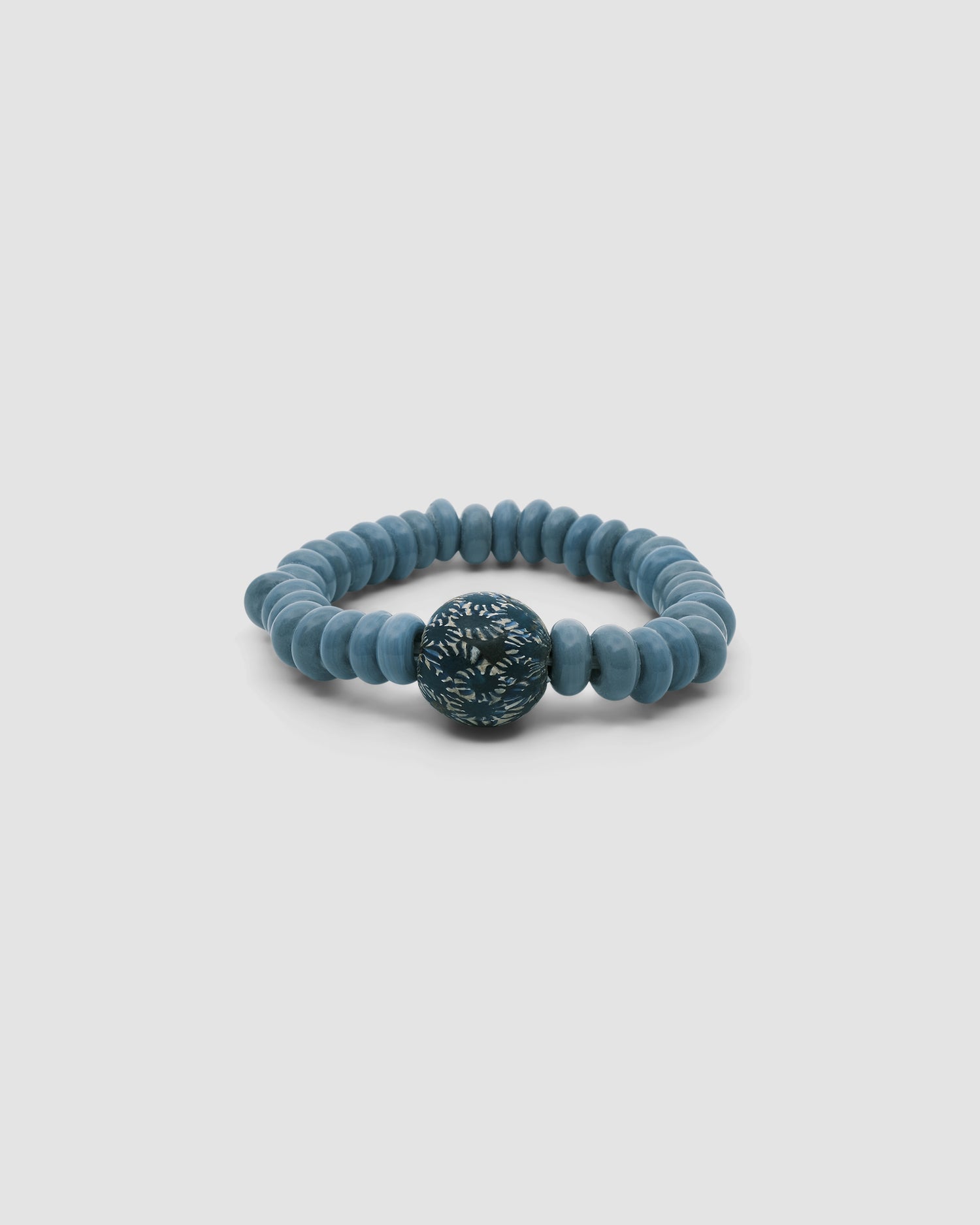 grey toned bracelet with an larger blue printed bead