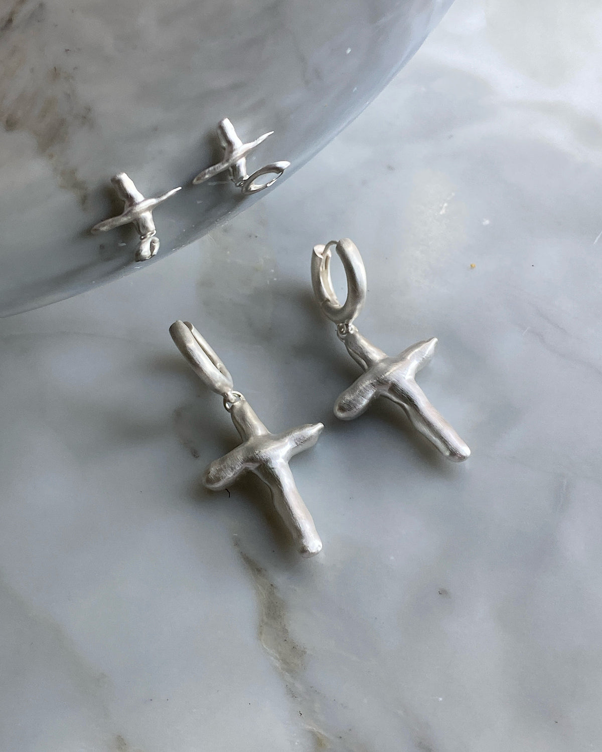 Uneven cross shaped sterling silver matt earrings by Fairley