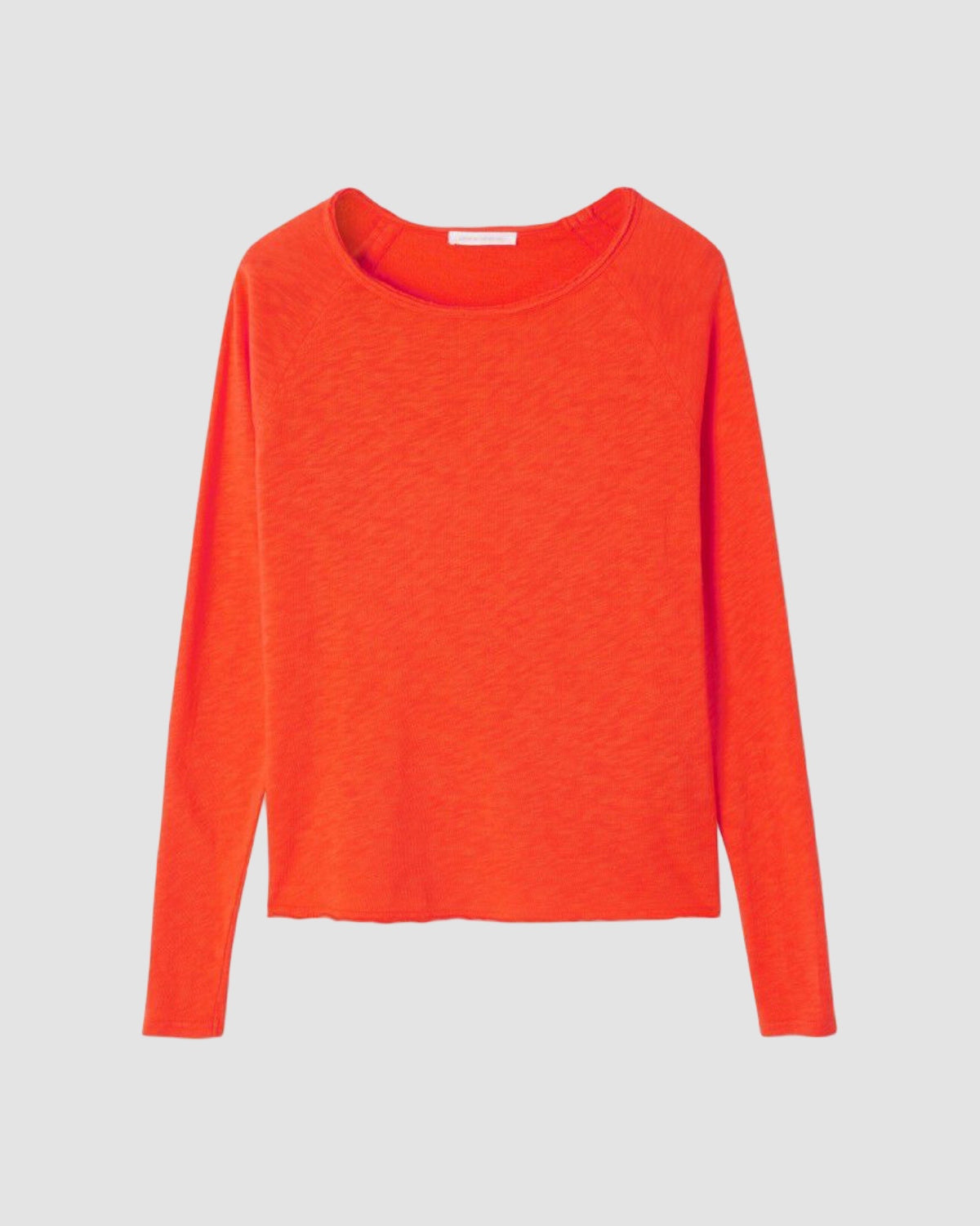Orange long-sleeve shirt on a light gray background