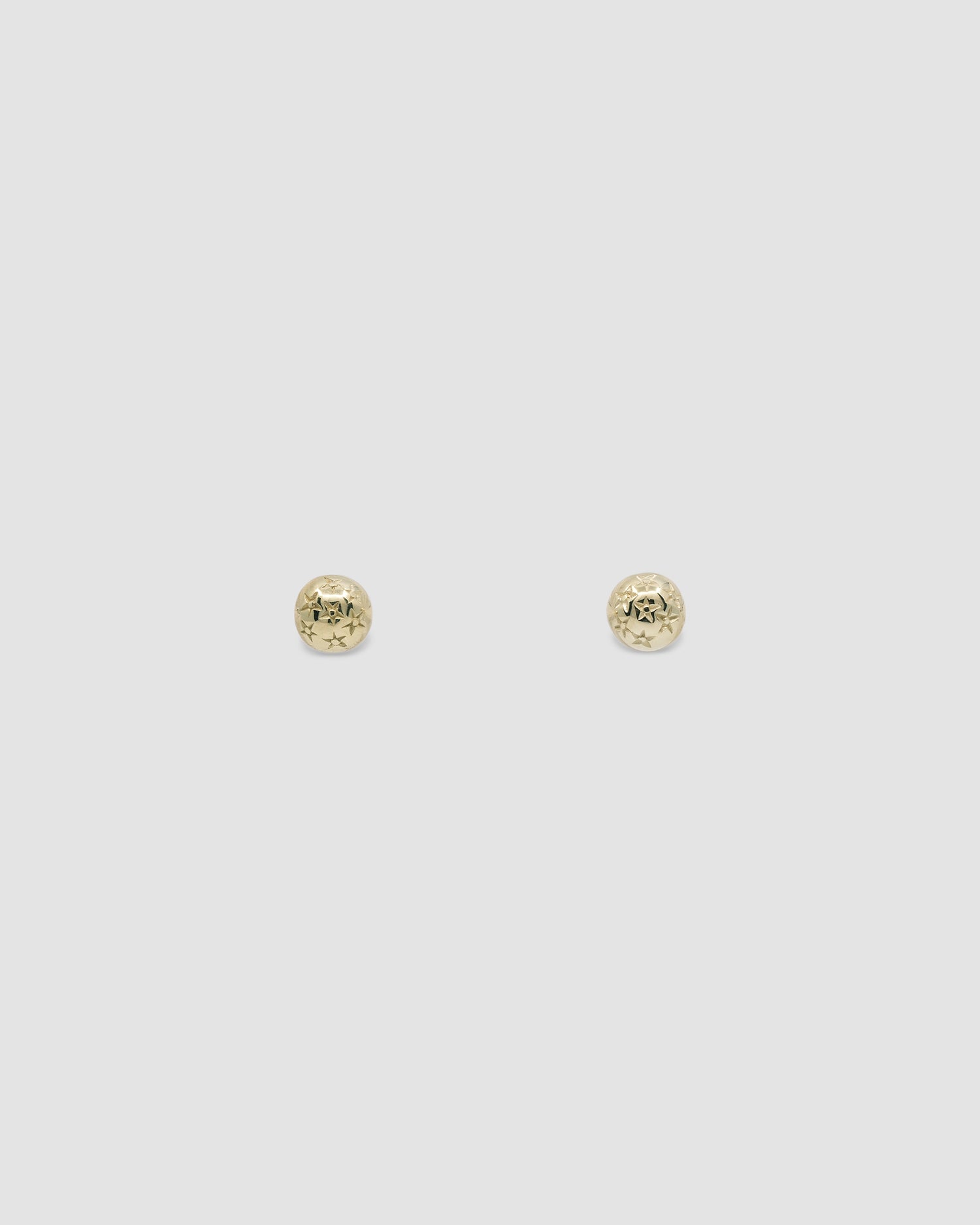 very small gold star stamped dome stud earrings