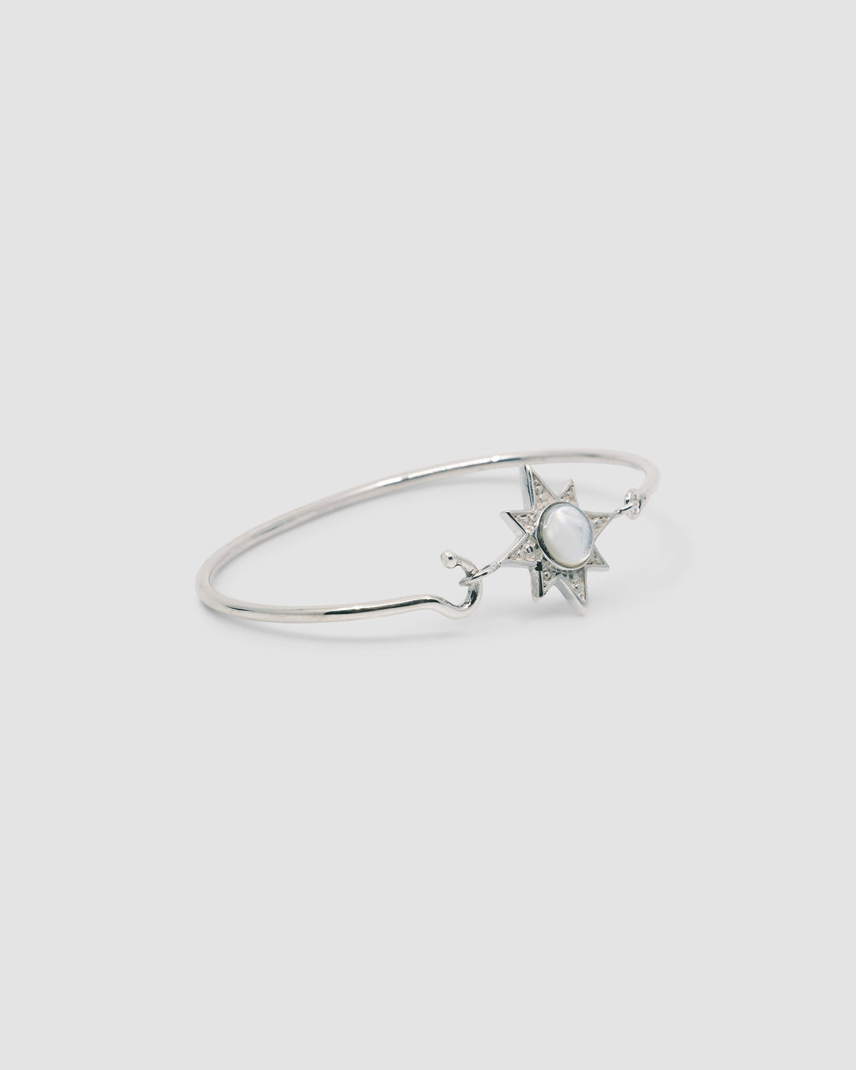 silver with mother or pearl inlaid star features on a thin silver wire clasp bracelet