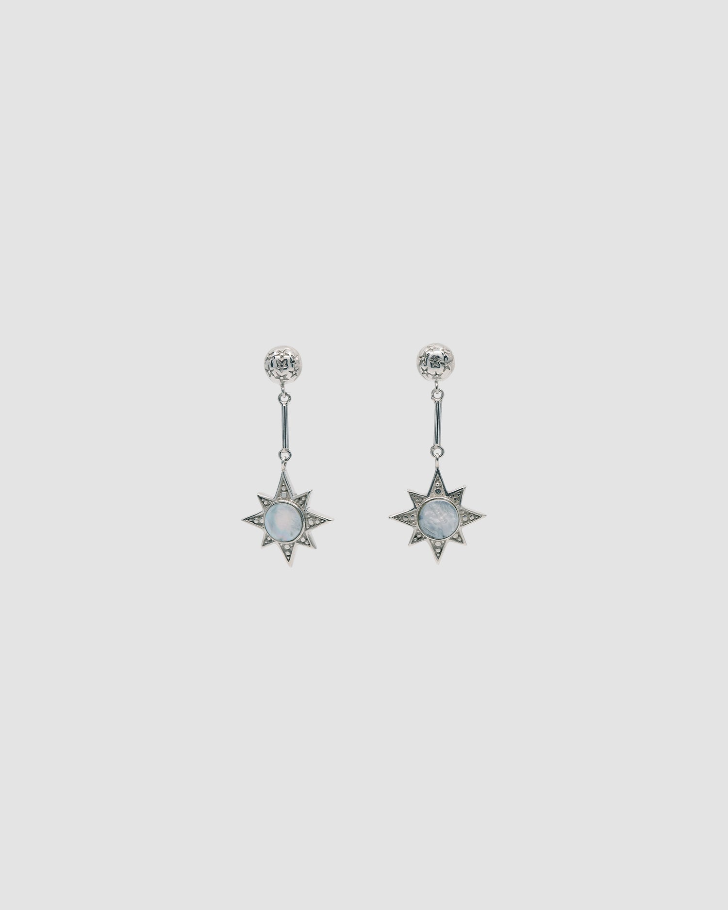 Silver drop earrings featuring a star stamped stud and shell inlaid star drop componant