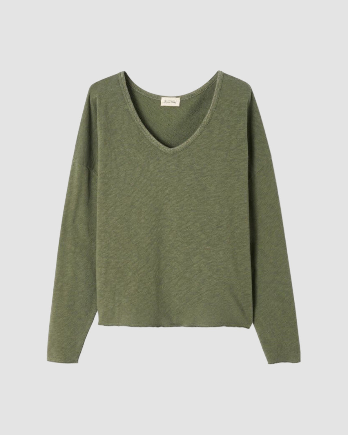 Green sweater on a light gray background